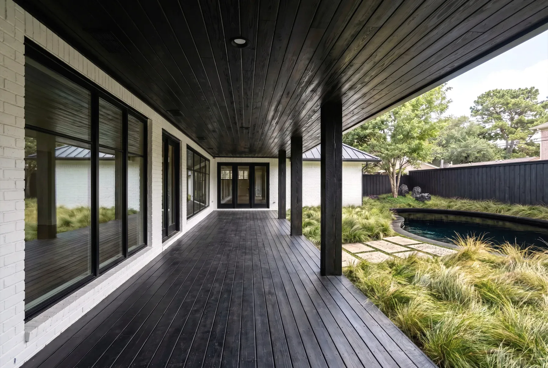 exterior-remodel-barton-creek-austin-charred-wood-porch-pool-01