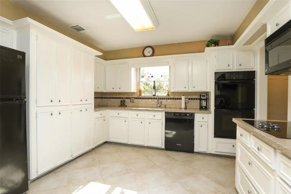 Before: Kitchen remodel in Hyde Park, Austin, TX with white cabinets and black appliances