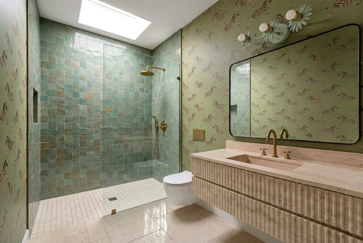Zilker bathroom with a green zellige-tile shower, zebra wallpaper and a fluted stone vanity