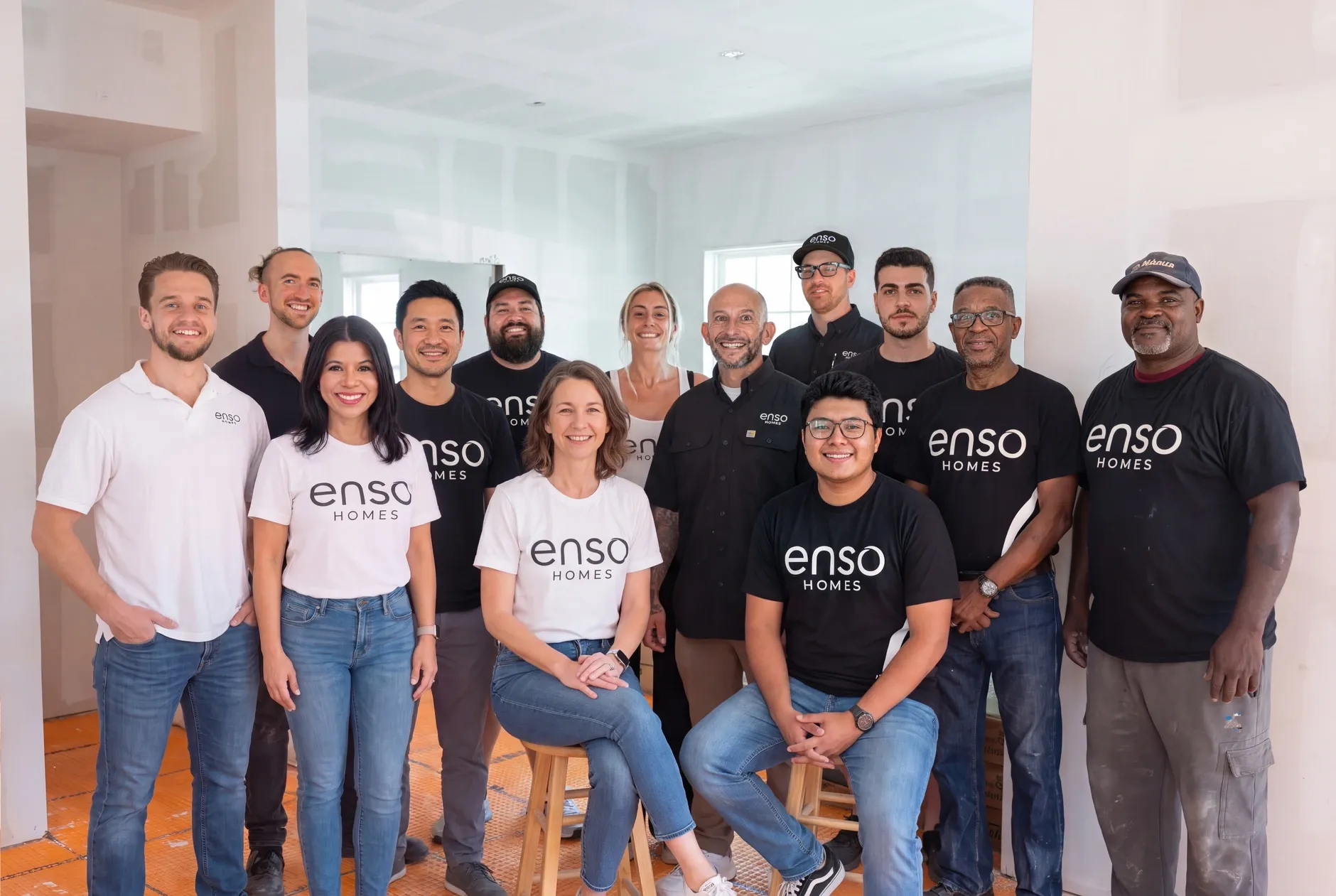 The Enso Homes team gathered inside an unfinished home