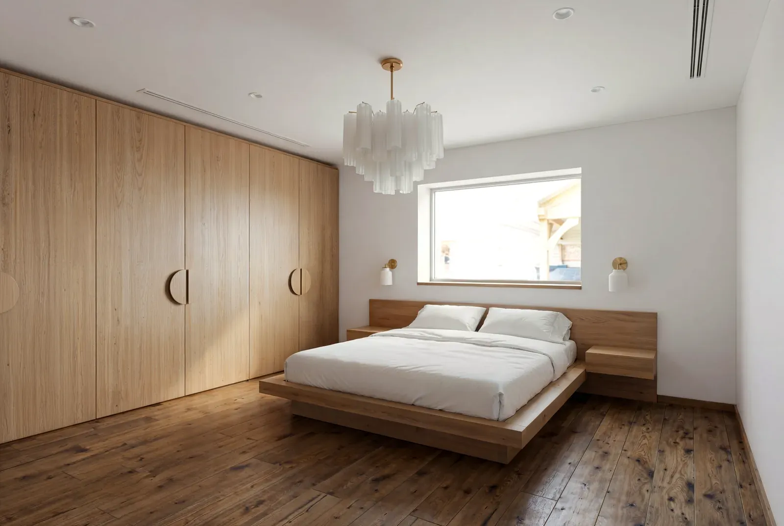Whole home remodel in Hyde Park, Austin, TX with a white oak wardrobe wall and a platform bed
