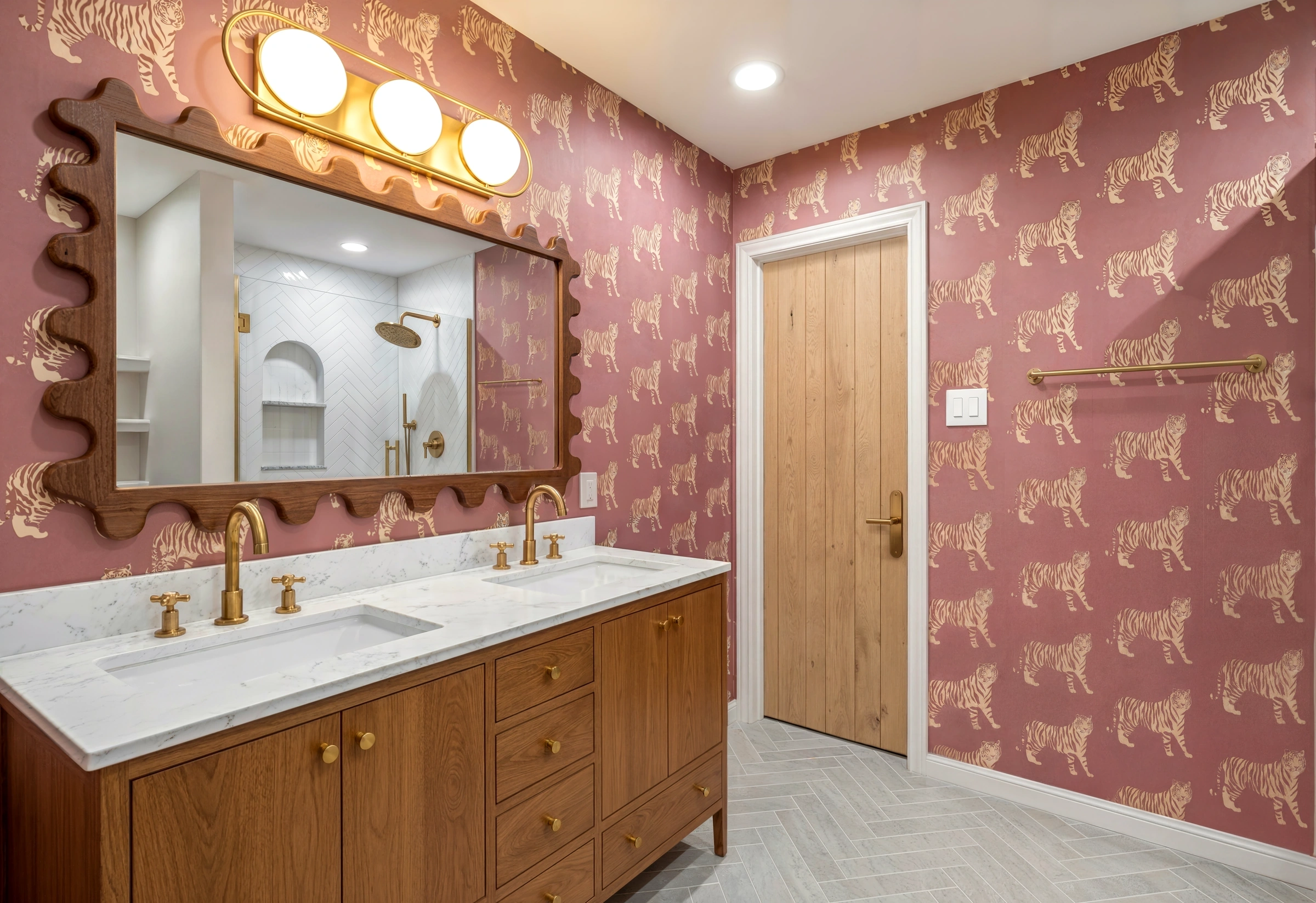 After: bathroom with patterned porcelain, a walnut vanity and a scalloped mirror