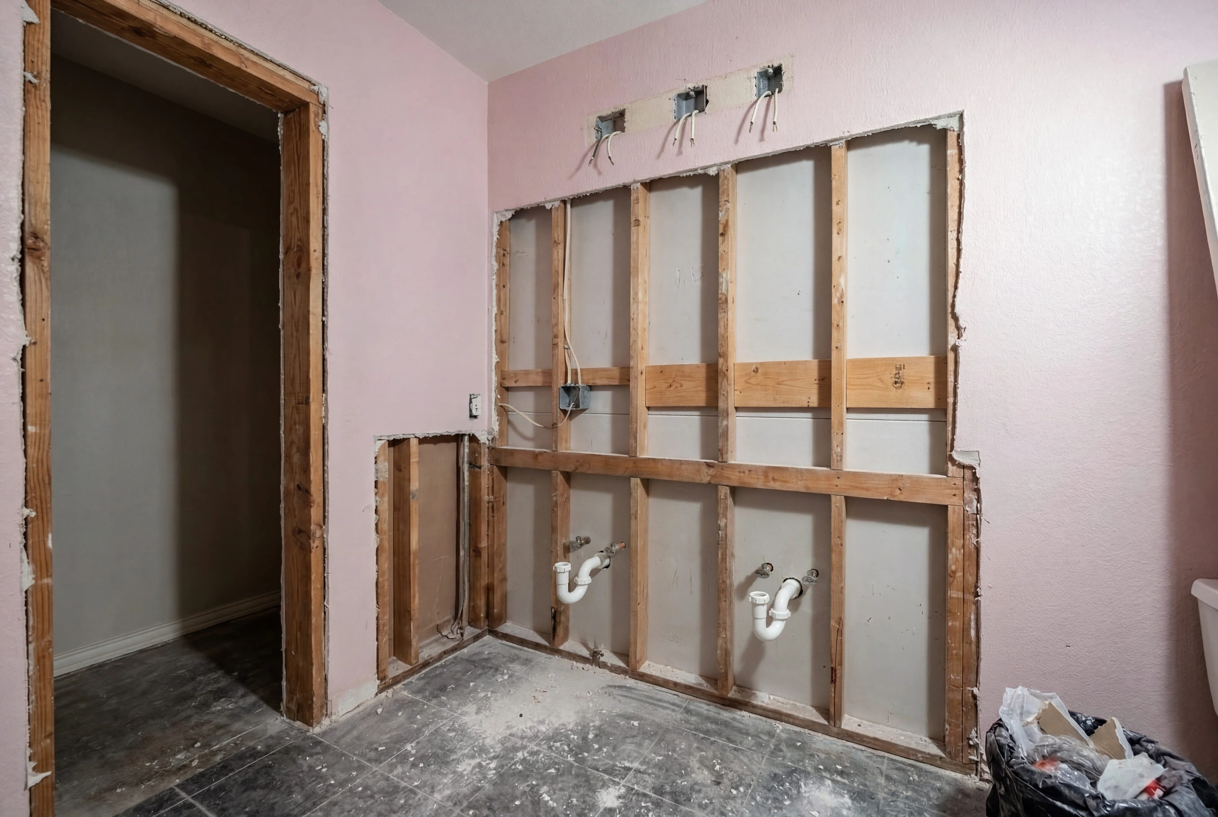 Bathroom under construction with waterproofing and framing exposed